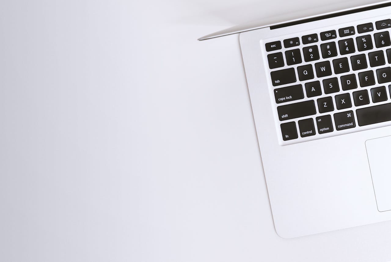 who-we-are-01 Aerial view of a sleek laptop keyboard on a clean, white surface, ideal for tech backgrounds.